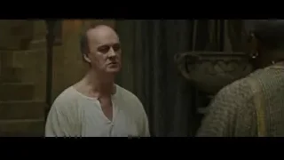 bald man deep in thought in stone room — Gladiator 2