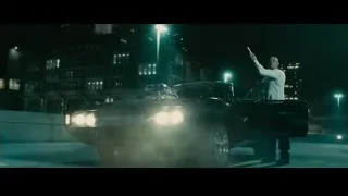 man with gun next to muscle car at night — Furious Seven