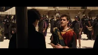 Man in red robe facing armored soldiers — Gladiator