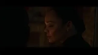 woman with serious expression in dimly lit room — Creed 3