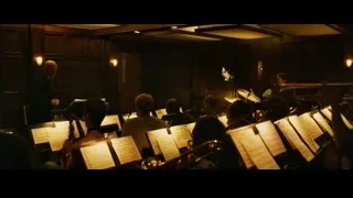 musicians rehearsing in dimly lit room — Whiplash