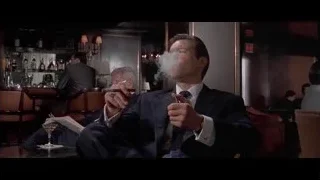 man in suit in bar reading newspaper — American Psycho