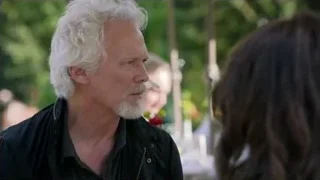 older man with beard conversing outdoors — Suits