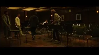 men playing instruments in dimly lit room — Whiplash