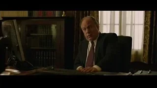 elderly man in suit at office desk — The Social Network