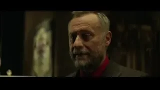 middle-aged man with beard in dimly room — John Wick