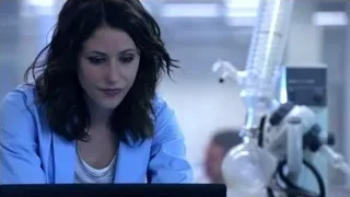 woman in lab coat looking at laptop — Suits