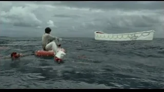 man sitting on boat in choppy ocean — Life of Pi