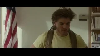 young man with backpack walking in hallway — Into the Wild