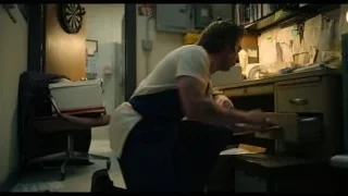 man working at cluttered office desk — The Bear