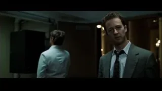 man in suit standing in dimly lit room — Fight Club