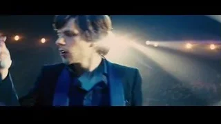 Young man speaking into microphone on stage — Now You See Me