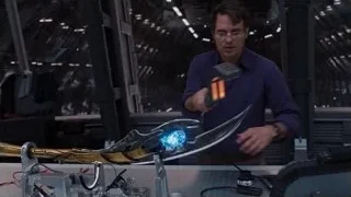 man working on glowing sword in control room — The Avengers