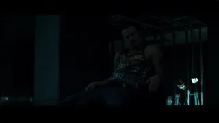 man in deep thought in dimly lit gym — Fight Club