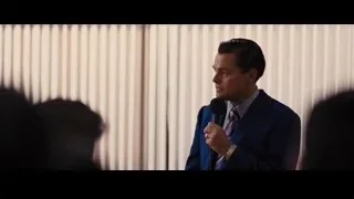 Man in suit speaking into microphone — The Wolf Of Wall Street
