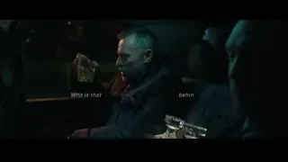 Man in suit speaking into microphone — John Wick