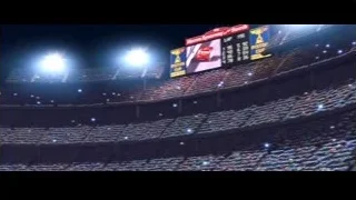 Crowded stadium at night with floodlights — Cars