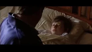 Young boy lying in bed looking up — Batman