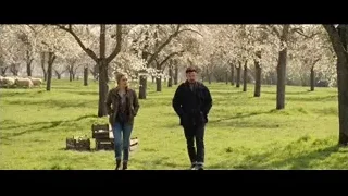 Man and woman walking through flowering trees — Doctor Strange 2