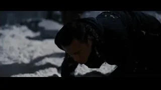person crouching in snowy landscape — Batman: The Dark Knight Rises