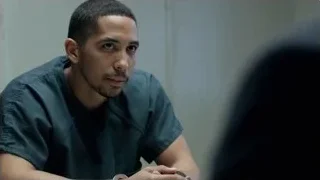 Young man in prison uniform at table — Suits
