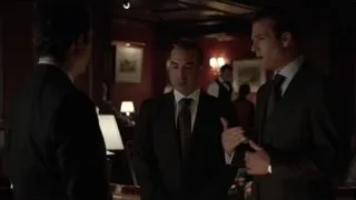 three men in formal attire conversing in dimly lit room — Suits