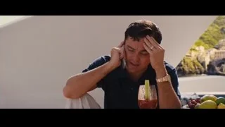man at table talking on phone with fruit — The Wolf Of Wall Street