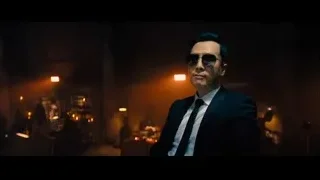 man in dark suit and sunglasses pointing — John Wick: Chapter 4