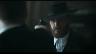 Man in hat holding gun looking intently — Peaky Blinders