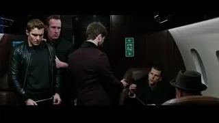 Man in handcuffs surrounded by other men — Now You See Me 2