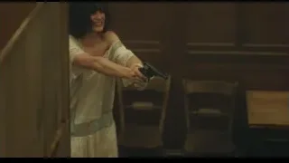 woman in white dress holding gun in wooden room — Peaky Blinders