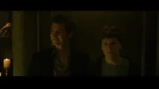 two men in dimly lit room with candle — The Social Network