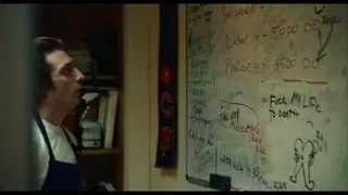 Young man by whiteboard with writing — The Bear