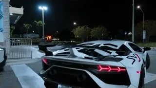 White Lamborghini parked in front of mural — Sports Cars