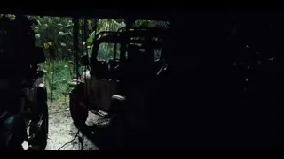 abandoned jeep in dark eerie forest — Jurassic World