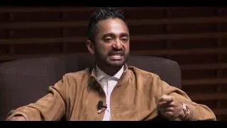 Man speaking on armchair in dimly lit room — The Social Dilemma
