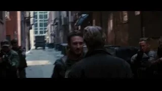 Two men in dimly lit alley, one with gun — Batman: The Dark Knight Rises