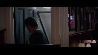 man in dark room with framed pictures — Creed