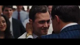 man in suit speaking into microphone — The Wolf Of Wall Street