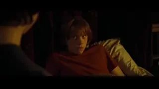 young man sitting on bed in dimly lit room — Harry Potter and the Goblet of Fire