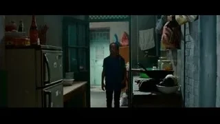 man holding hammer by car in dim room — The Karate Kid