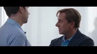 two men conversing while walking in hallway — The Big Short