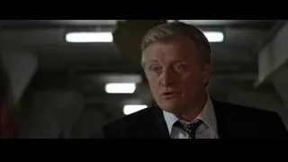 Older man in suit with serious expression — Batman