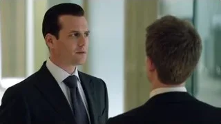 two men in suits in indoor hallway — Suits