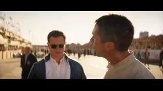 two men standing on beach — Ford v Ferrari