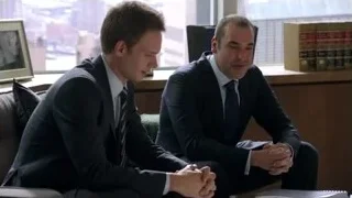 Two men in suits conversing in office — Suits