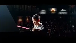Young boy playing piano in auditorium — The Karate Kid