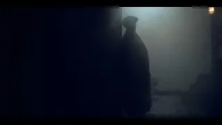 man holding gun in dark foggy room — Peaky Blinders