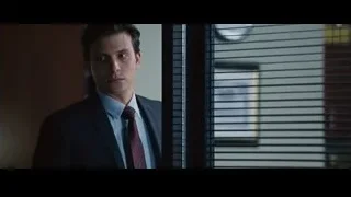 man in suit standing by window — The Big Short