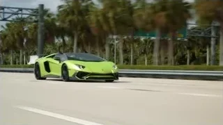 Green Lamborghini driving on highway — Sports Cars
